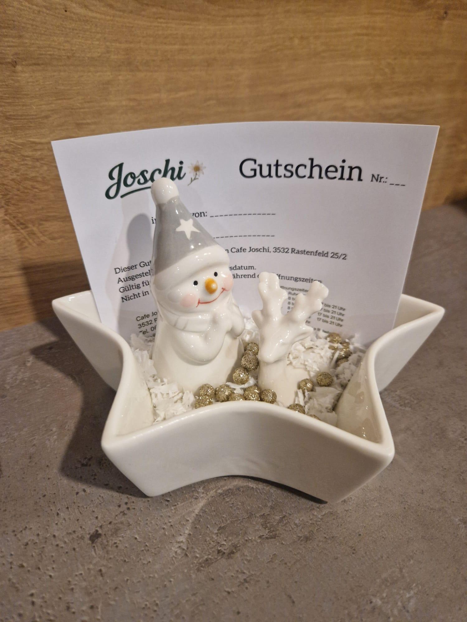Joschi-Gutschein in einer Sternschale mit Schneemann